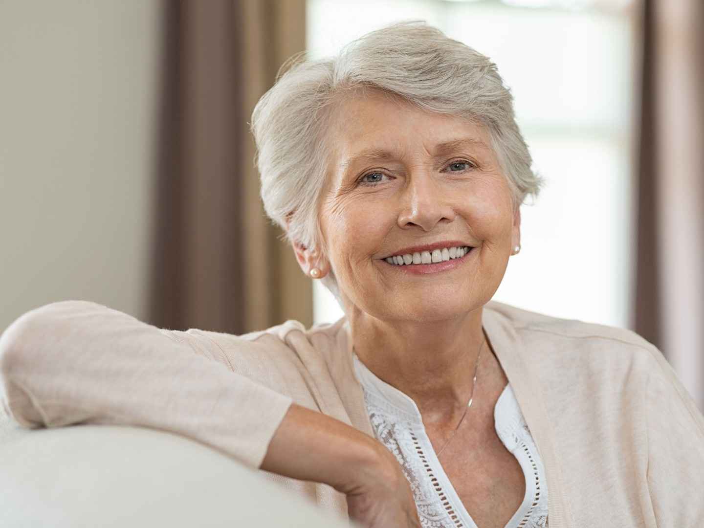 Ältere Dame lächelt in die Kamera.