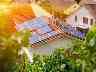Sonne scheint auf eine Photovoltaik-Anlage auf dem Dach eines Hauses.
