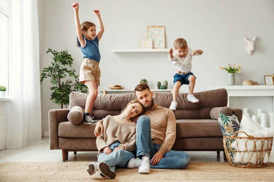 Kinder toben um ihre müden Eltern herum
