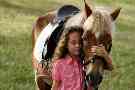 Mädchen genießt das Zusammensein mit seinem Pferd.